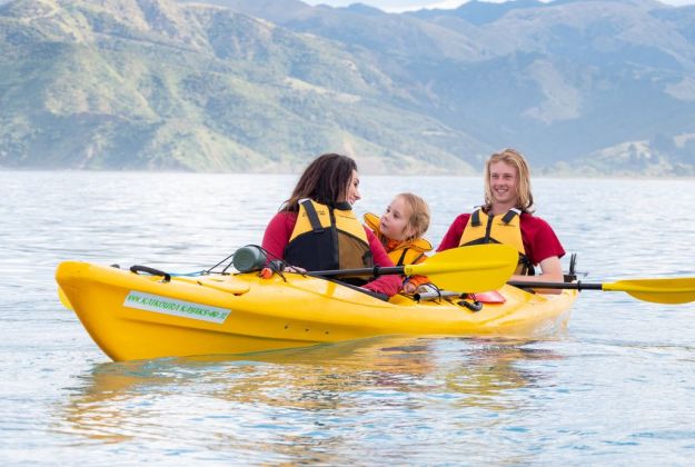 A young family kayaking off the coast of Kaikoura